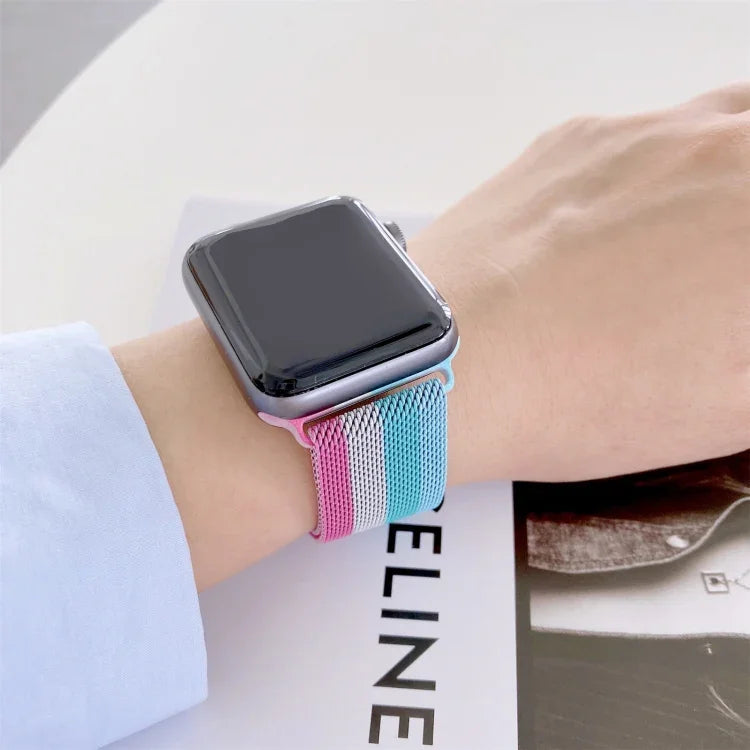 Four-colors Milanese replacement strap for Apple Watch Series 7 on wrist, stylish and comfortable design.